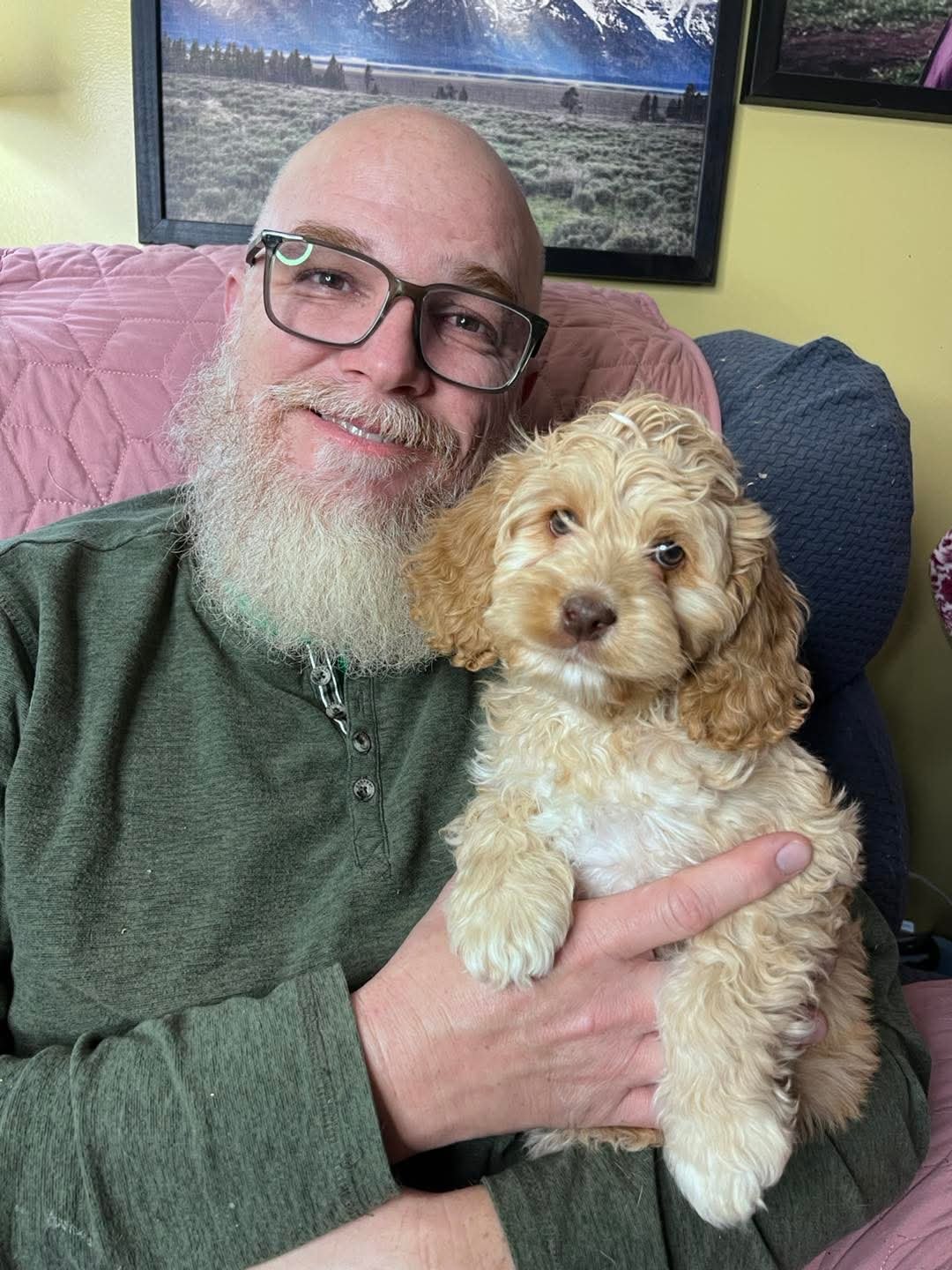 Steev holding a small puppy — our flight nanny ready to deliver your new family member